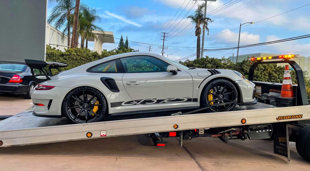 Porsche on a flatbed tow truck