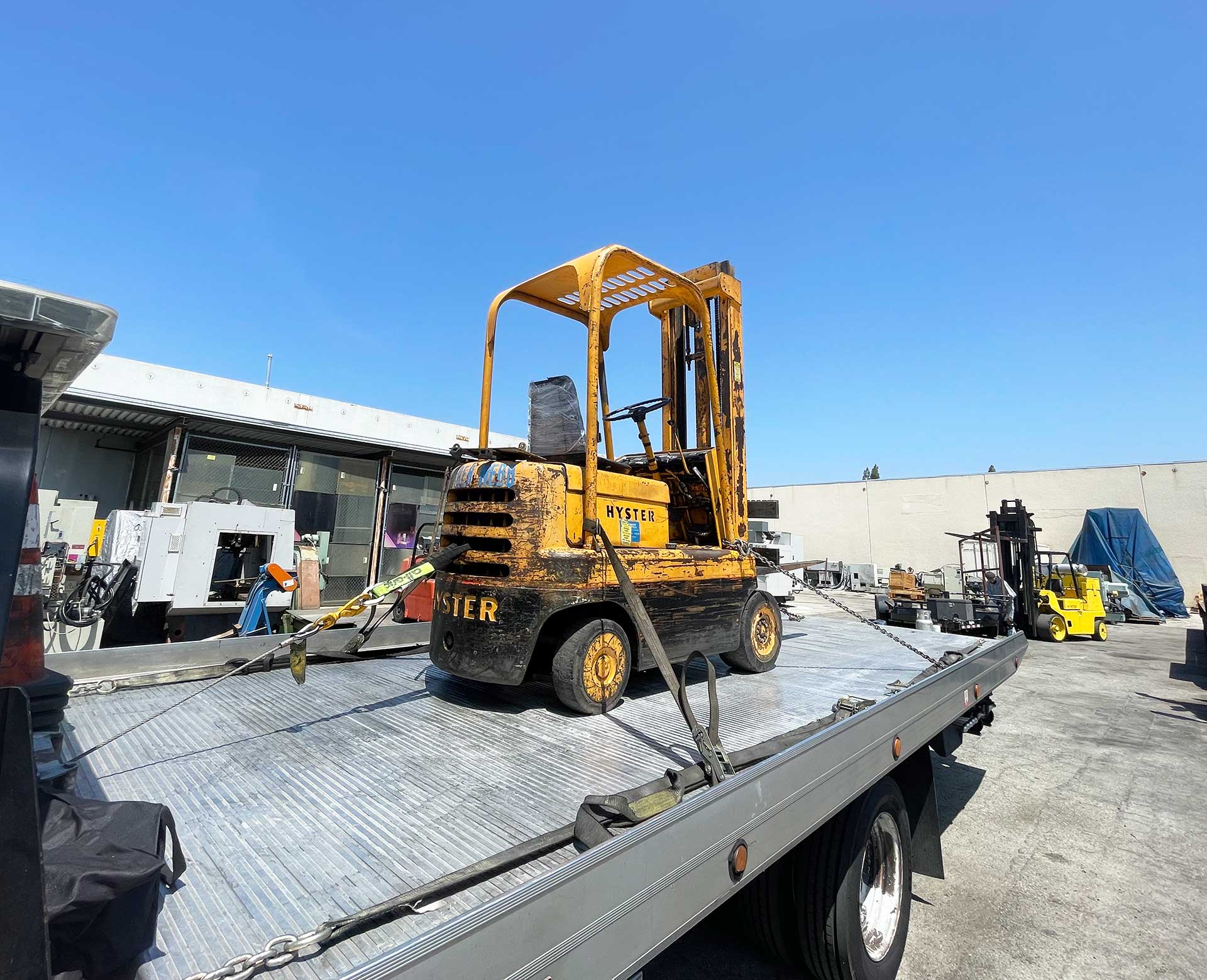 Forklift being tranported by flatbed