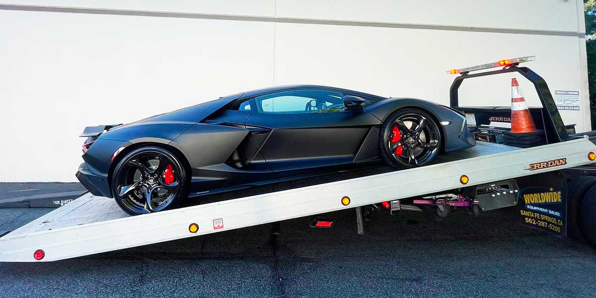 Lamborghini being towed on Flatbed truck