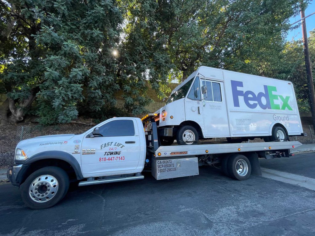 Towing a Fedex delivery truck